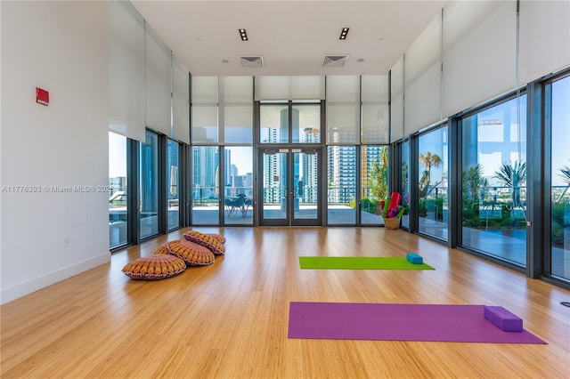 1600 NE 1st Ave Unit 2615, Miami, FL 33132 - workout area with wood finished floors, plenty of natural light, floor to ceiling windows, and a towering ceiling