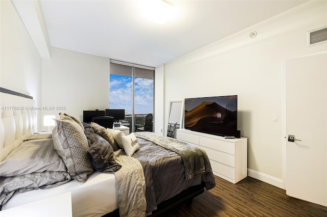 bedroom featuring access to exterior, floor to ceiling windows, dark wood-style floors, baseboards, and visible vents