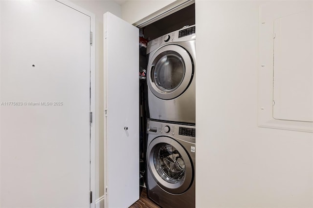 laundry area featuring stacked washer / dryer and laundry area