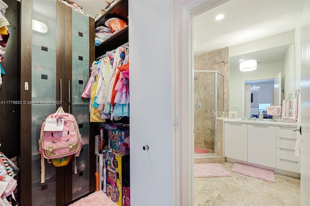 full bathroom with recessed lighting, a stall shower, a walk in closet, and vanity