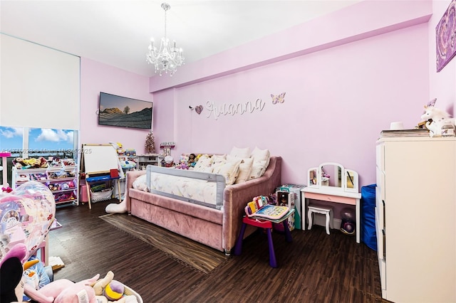 bedroom featuring wood finished floors and a notable chandelier