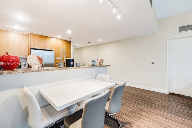 dining room with recessed lighting, baseboards, visible vents, track lighting, and wood finished floors