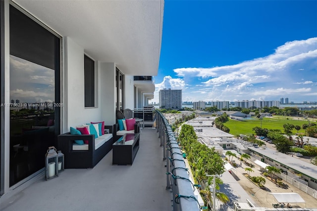balcony with outdoor lounge area and a view of city