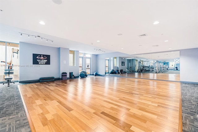 gym with visible vents, rail lighting, baseboards, wood finished floors, and recessed lighting