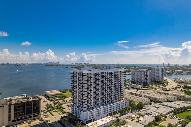 birds eye view of property featuring a water view and a view of city