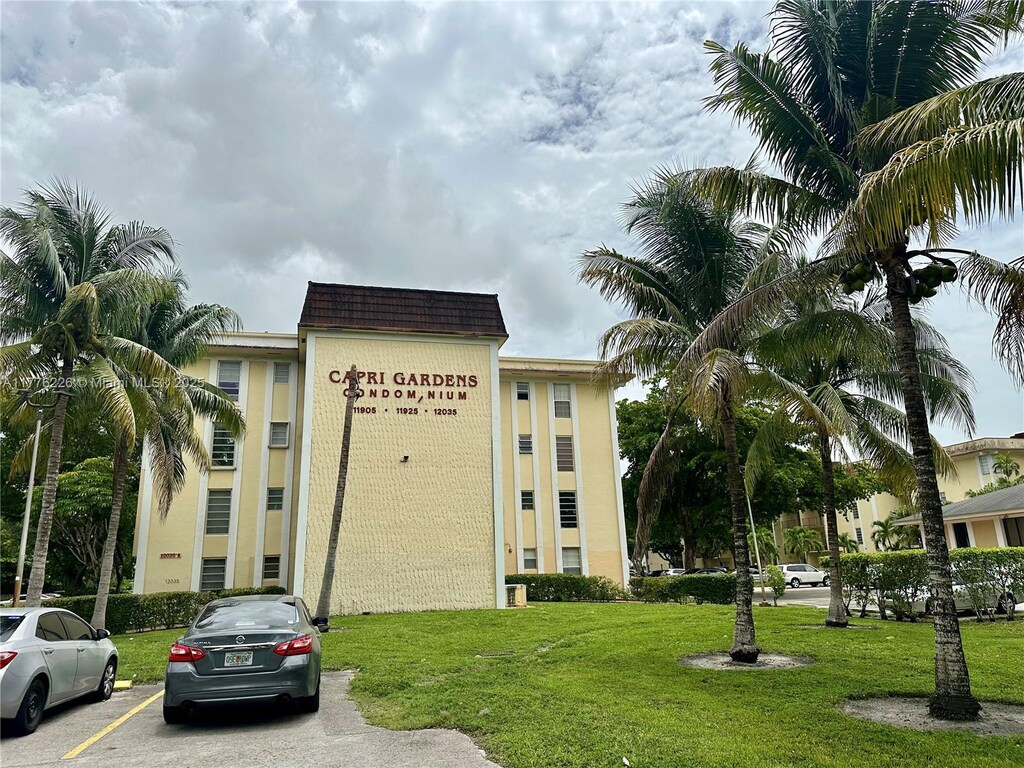 view of building exterior with uncovered parking
