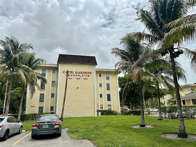 view of building exterior with uncovered parking