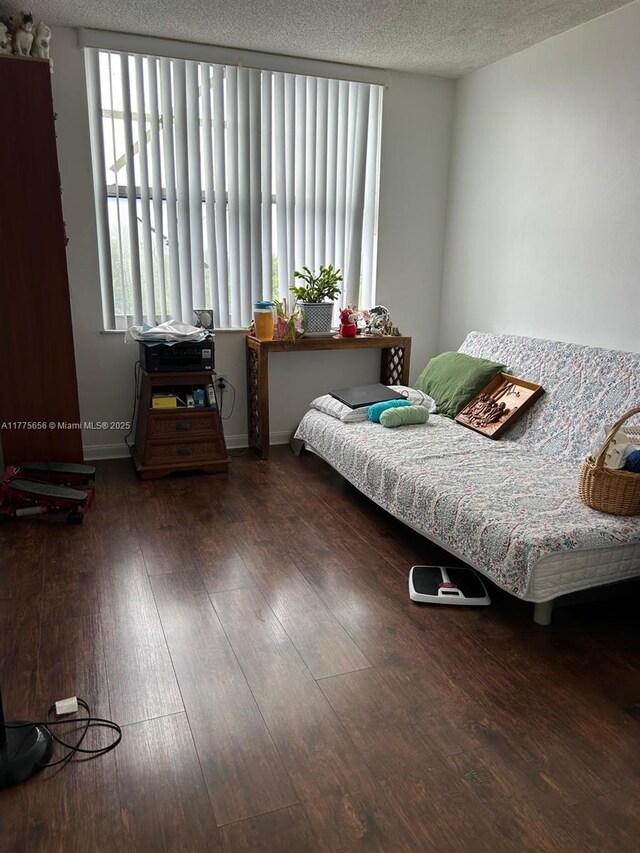 17890 W Dixie Hwy Unit 714, North Miami Beach, FL 33160 - bedroom featuring baseboards, a textured ceiling, and hardwood / wood-style flooring