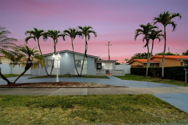 9215 SW 44th St, Miami, FL 33165 - ranch-style home with curved driveway, fence, stucco siding, and a front yard