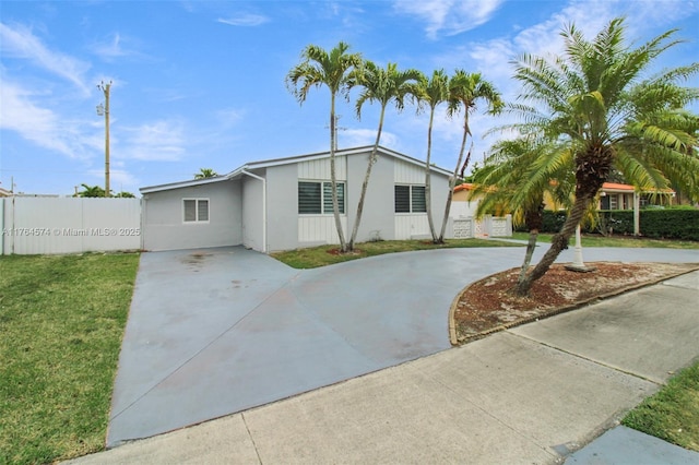 9215 SW 44th St, Miami, FL 33165 - ranch-style home with fence, curved driveway, a front yard, and stucco siding