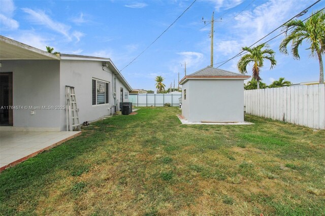 9215 SW 44th St, Miami, FL 33165 - view of yard featuring an outdoor structure, a fenced backyard, and central AC