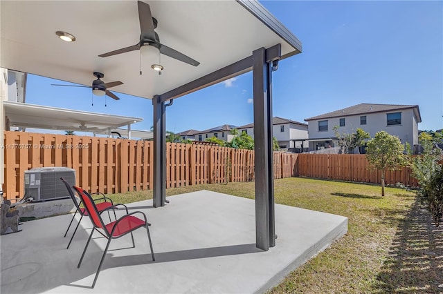 view of patio featuring a fenced backyard, central AC unit, a residential view, and ceiling fan