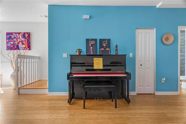 sitting room featuring baseboards and wood finished floors