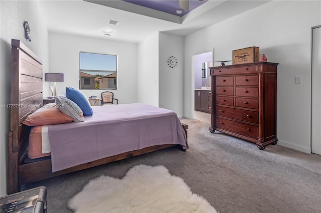 bedroom featuring carpet, ensuite bath, baseboards, and visible vents