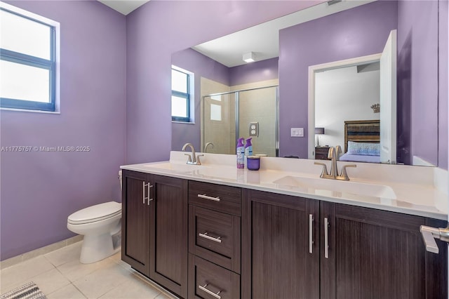 bathroom featuring ensuite bathroom, a sink, a shower stall, and toilet
