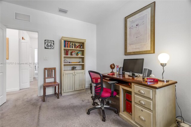 home office with baseboards, visible vents, and light colored carpet