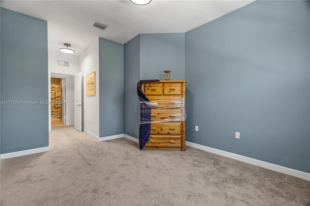 carpeted bedroom featuring baseboards and visible vents