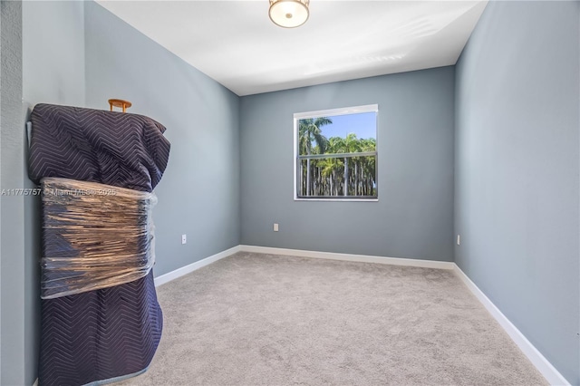unfurnished room featuring baseboards and carpet flooring