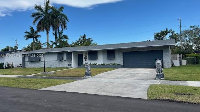 9380 SW 179th Ter, Palmetto Bay, FL 33157 - ranch-style home with a front lawn, driveway, a garage, and stone siding