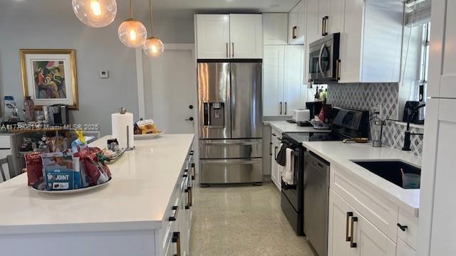 9380 SW 179th Ter, Palmetto Bay, FL 33157 - kitchen with appliances with stainless steel finishes, tasteful backsplash, white cabinets, and light countertops