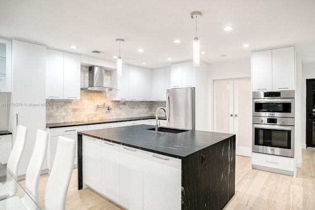 3543 S Ocean Blvd Unit 103, South Palm Beach, FL 33480 - kitchen featuring appliances with stainless steel finishes, wall chimney range hood, modern cabinets, white cabinets, and recessed lighting