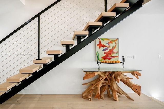 3543 S Ocean Blvd Unit 103, South Palm Beach, FL 33480 - staircase with wood finished floors and baseboards