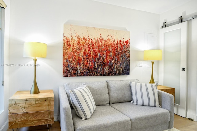 3543 S Ocean Blvd Unit 103, South Palm Beach, FL 33480 - living area with a barn door and wood finished floors