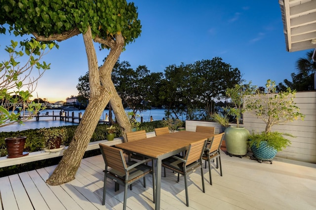 3543 S Ocean Blvd Unit 103, South Palm Beach, FL 33480 - deck at dusk with outdoor dining area and a water view