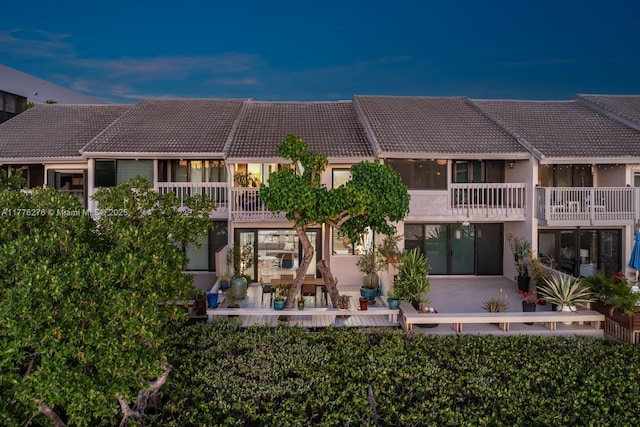 3543 S Ocean Blvd Unit 103, South Palm Beach, FL 33480 - rear view of house featuring a tiled roof, a balcony, and a patio