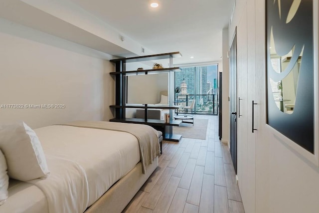 398 NE 5th St Unit 1408, Miami, FL 33132 - bedroom with wood tiled floor, floor to ceiling windows, and recessed lighting