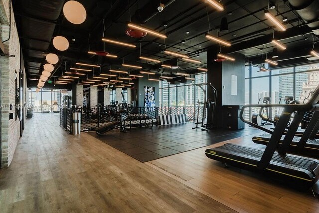 398 NE 5th St Unit 1408, Miami, FL 33132 - exercise room with floor to ceiling windows, a healthy amount of sunlight, and wood finished floors