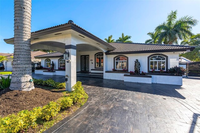 mediterranean / spanish home with stucco siding and a tiled roof