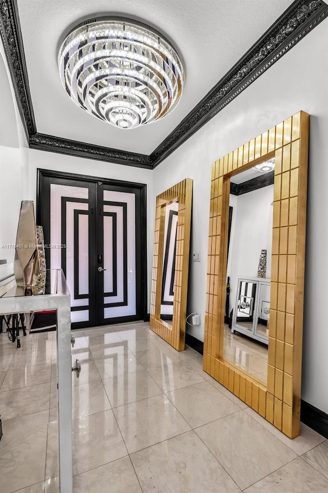 foyer featuring baseboards and crown molding