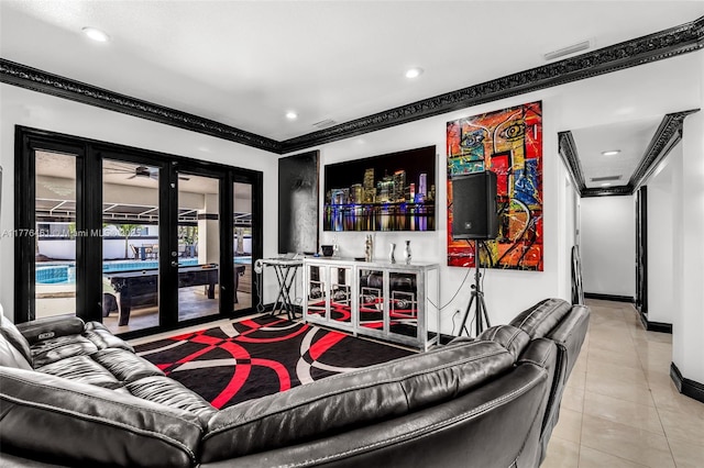 living room featuring baseboards, crown molding, tile patterned flooring, and french doors