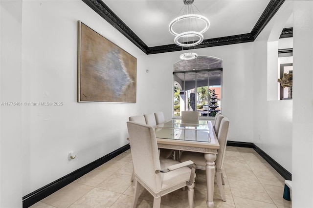 tiled dining area with baseboards, ornamental molding, and a chandelier