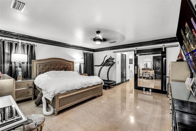 bedroom with crown molding, visible vents, a barn door, and a ceiling fan