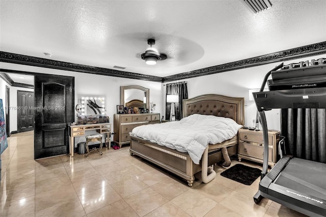 bedroom featuring ornamental molding, a textured ceiling, and visible vents