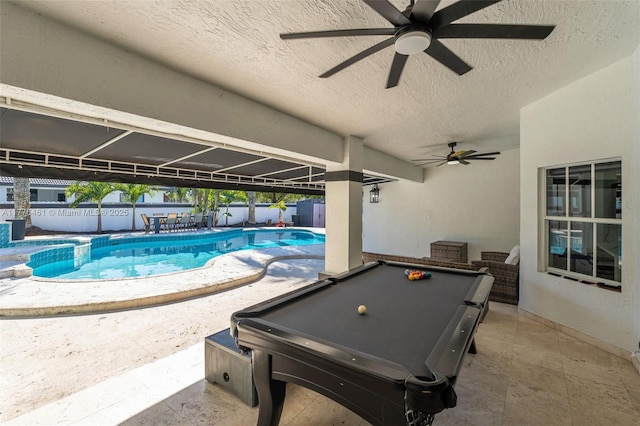 pool with ceiling fan, outdoor dining space, fence, and a patio area