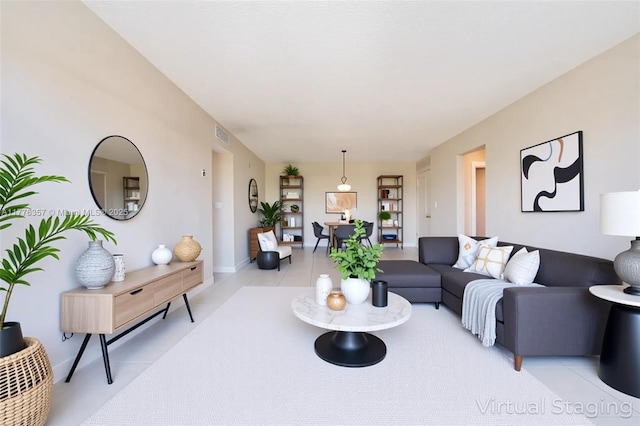 living area featuring visible vents and light tile patterned floors