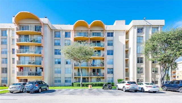 view of building exterior featuring uncovered parking