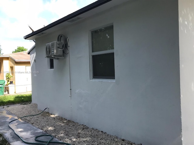 view of property exterior with ac unit, stucco siding, and fence