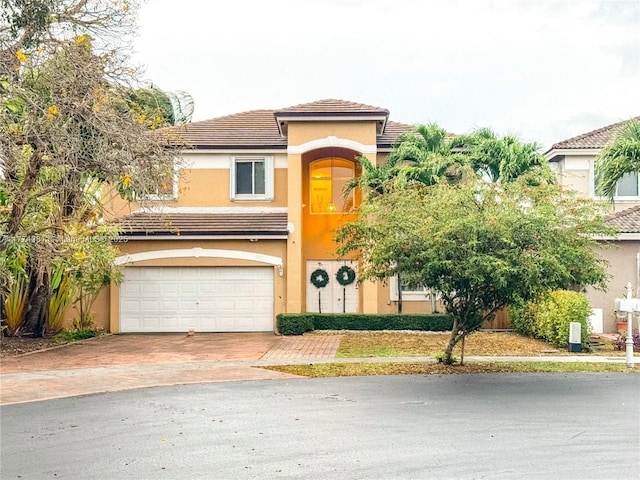 15809 SW 65th Ter, Miami, FL 33193 - view of front of house featuring a tile roof, a garage, driveway, and stucco siding