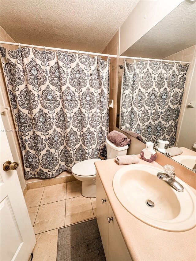 15809 SW 65th Ter, Miami, FL 33193 - bathroom with a shower with shower curtain, toilet, vanity, a textured ceiling, and tile patterned flooring
