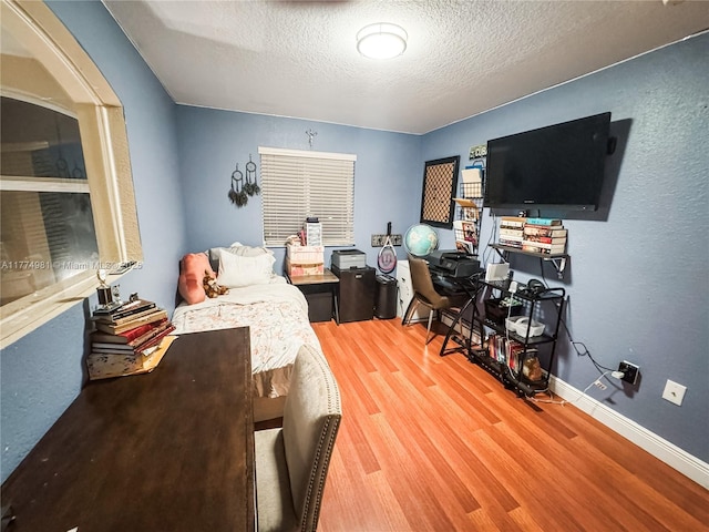 15809 SW 65th Ter, Miami, FL 33193 - bedroom with baseboards, a textured ceiling, and wood finished floors
