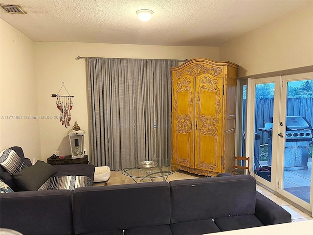 15809 SW 65th Ter, Miami, FL 33193 - tiled living area featuring french doors, a textured ceiling, and visible vents