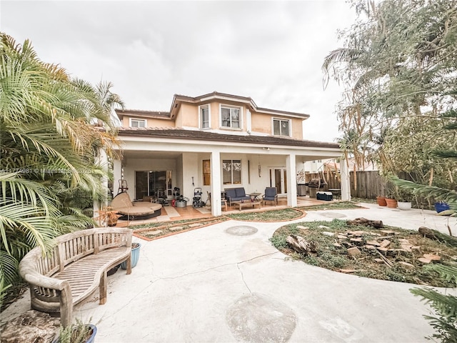 15809 SW 65th Ter, Miami, FL 33193 - rear view of house with outdoor lounge area, stucco siding, fence, and a patio area
