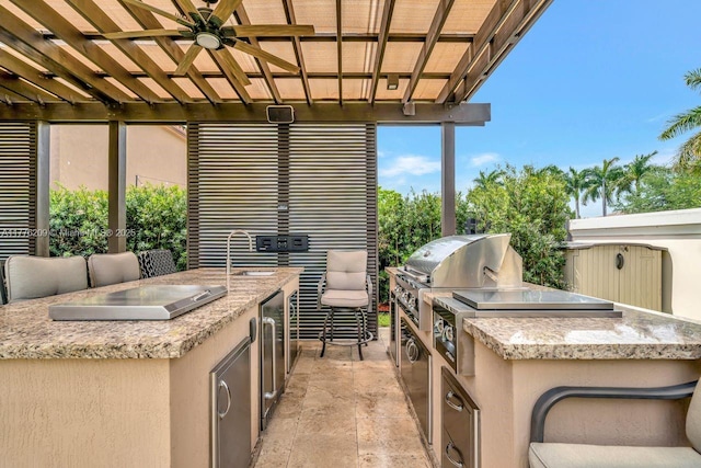 view of patio with exterior kitchen, a sink, and area for grilling
