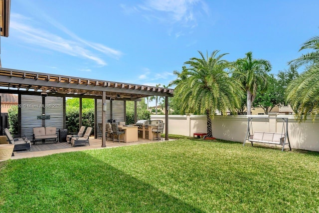view of yard with fence, a pergola, outdoor lounge area, exterior kitchen, and a patio