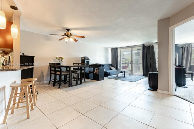 1680 NE 191st St Unit 307-2, Miami, FL 33179 - dining area featuring ceiling fan, plenty of natural light, light tile patterned floors, and baseboards