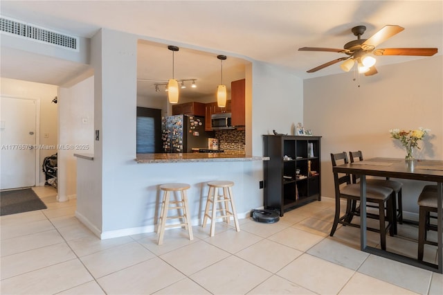 1680 NE 191st St Unit 307-2, Miami, FL 33179 - dining space with light tile patterned floors, a ceiling fan, and baseboards